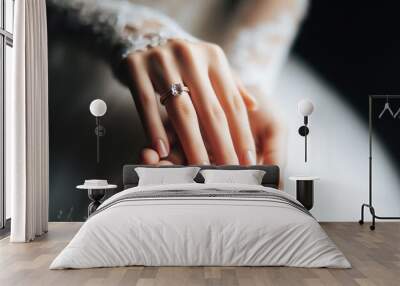 Close-up of the bride's hands and fingers at the wedding hand and engagement ring Woman wearing a white wedding dress Wall mural