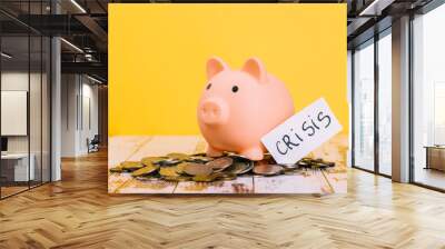 Pink piggy bank on wooden table and yellow background. The concept of storage, accumulation. Crisis, inflation, financial collapse. Wall mural