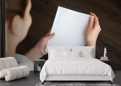 top view of a woman reading an open book or magazine. empty page. mock up Wall mural