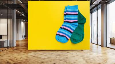 View from above. Socks are scattered on a yellow background. Clothing in the form of socks. Wall mural