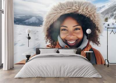 Beautiful young black woman smiling and happy, taking a selfie in snowy mountains. Winter travel and outdoor activities concepts. Wall mural