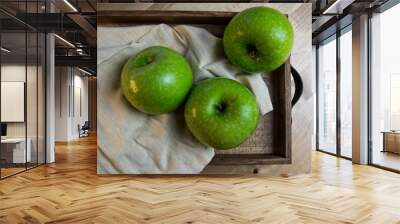 Still life of fruit, with 3 green apples on a wooden tray. Closeup and depth of field Wall mural