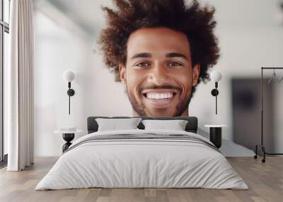 Young black man with afro hair smiling with perfect smile and white teeth. Wall mural