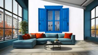 blue window with open shutters and white wall of greek house in amorgos, greece. Wall mural