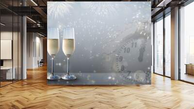 New Years eve concept with two glasses of bubbly champagne on a silver grey colored design background. Wall mural