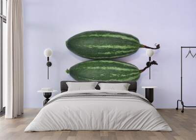 Closeup shot of two zucchinis on a light-colored background Wall mural