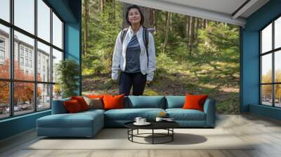 Young asian woman walking in the forest during a hike in summer Wall mural