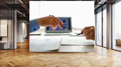 Desk-bound businessman calculates figures, verified accounts, and collaborates in discussions. Proficient in using calculators, aiding each other, and managing annual tax accounts in the audit office Wall mural