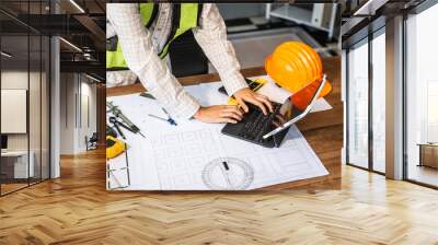 Female architect engineer is drafting blueprints using CAD software, focusing on sustainable infrastructure, renewable energy solutions, and adhering to building codes Wall mural