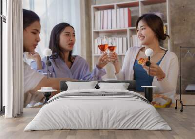 Group of young asian office girl friends having fun and celebrating pizza on table during party Wall mural