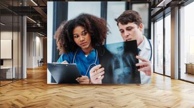 Medical staff team african american meeting discussing chest x-ray film Radiologists medical doctors that specialize in diagnosing, treating injuries, diseases, radiology, procedures exams, tests Wall mural