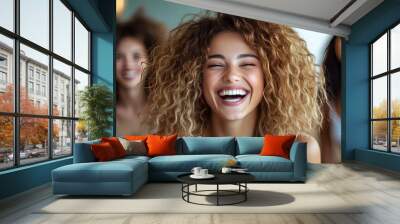 Laughing friends enjoying time indoors, showcasing joy and connection. Wall mural