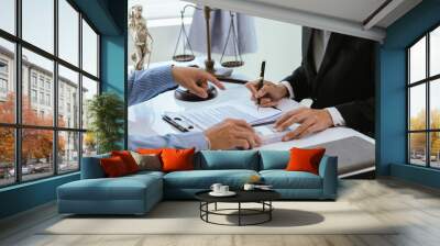 A professional lawyer advises a client in a corporate office, discussing legal documents, contracts, and finance. They consult on justice, legislation, and agreements during an important legal meeting Wall mural