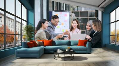 Teams of men and women use technology for data analysis, brainstorming, and presentations, fostering teamwork and effective communication for business success.
 Wall mural