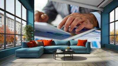 A businessperson using an iPad to review documents Wall mural