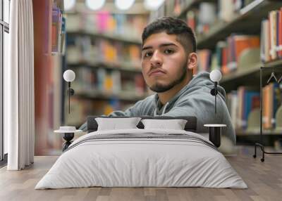 A Hispanic college student studying in a library Wall mural