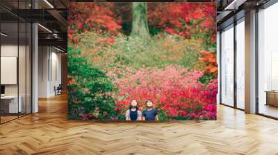 Two young asian girls meditating in colorful garden in spring Wall mural