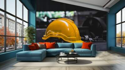 Yellow hard safety helmet hat and dark background. Engineer, Construction and Safety Concept. Copy Space. Wall mural