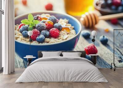 A bowl of freshly cooked oatmeal with berries and honey on a rustic wooden table, morning sunlight streaming in. Wall mural