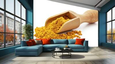 A small pile of turmeric powder spilling out of a wooden scoop, isolated on a white background Wall mural