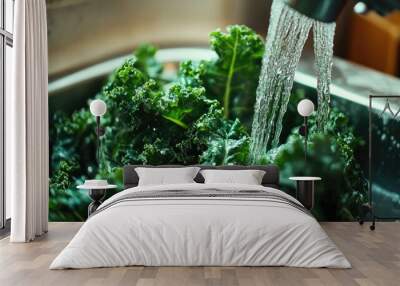 Close-up of kale leaves being washed under running water in a sink, preparing for a healthy meal Wall mural