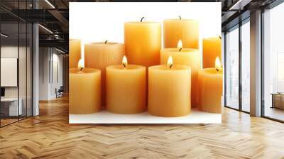 Group of pillar candles with bright flames burning softly on a white background Wall mural