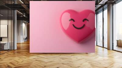 Heart emoji on a pastel pink background, symbolizing love and affection, perfect for romantic or caring designs. Wall mural