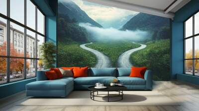 A serene landscape featuring a winding road splitting into two paths, surrounded by lush green fields and majestic mountains shrouded in mist. Wall mural