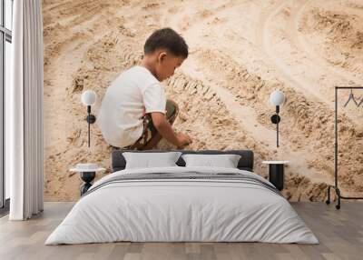 Cute little boy play sand Wall mural