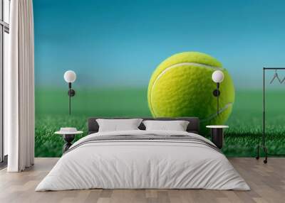 A tennis ball on the grass, with a blue sky in the background, in a clean and simple style, with a wide angle lens, at high resolution, with detailed texture of the green grass, and clear details of Wall mural