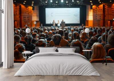 The audience sits in front of the stage. Watch experts present in a business meeting with a white screen and podium on a bright background. The crowd is a diverse group. Wall mural