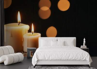 Two burning candles with bokeh lights in background Wall mural