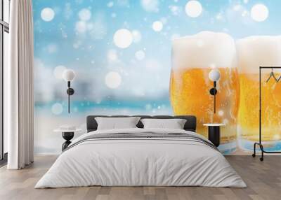 Two glasses of beer on a beach with a blue sky background. Wall mural