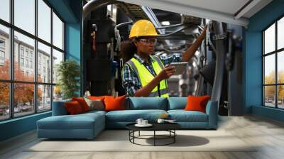 Female engineer wearing a yellow safety vest and yellow helmet  working check Industry cooling system, HVAC of large industrial building  Wall mural