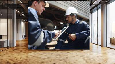 maintenance and technician railway checking the power train of oil cargo train and the railway work on railroad station with tablet. Wall mural