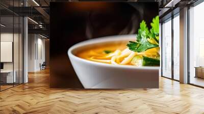 A steaming bowl of delicious soup garnished with fresh herbs and vegetables, perfect for a cozy meal or a foodie moment. Wall mural