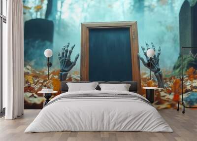 A spooky graveyard scene featuring a chalkboard frame with skeletal hands emerging from colorful autumn leaves. Wall mural