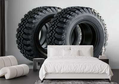 Two rugged tires displayed on a plain background, showcasing their tread patterns and robust design, ideal for off-road vehicles. Wall mural