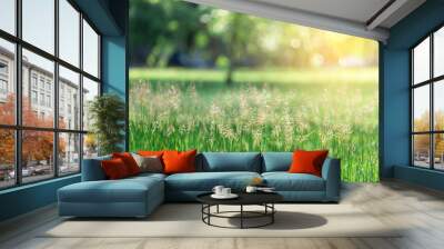 The grass field swaying with the wind and the sun, the morning in the garden. Wall mural