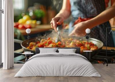 Close-up of a chef stirring food in a pan on a stovetop. Wall mural