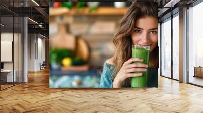 Smiling woman enjoying a healthy green smoothie. Wall mural