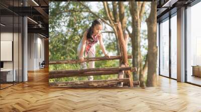 happy little asian girl child having fun to playing in the playground in summer time with smile and laughing healthy, funny smiling face adorable lovely female kid. happy vacation lifestyle concept. Wall mural