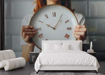 Woman holding a vintage clock in a modern kitchen, highlighting the blend of old and new elements with Roman numerals and white tiles. Wall mural