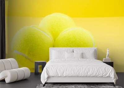 Tennis balls on yellow background Wall mural