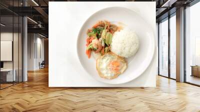 Fried Savory sauteed mixed vegetables with shimp and fried egg served with rice in white dish on white background as Thai homemade meal or recipe in the restaurant. Thai style food. Wall mural