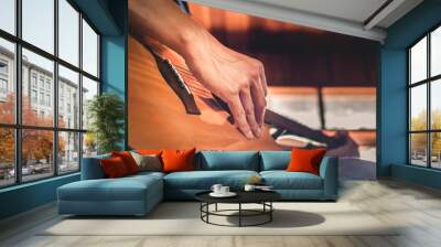 Close-up of the hands and fingers of a male musician playing an acoustic guitar.Musical guitar instrument for recreation or Relax hobby passion concept. Wall mural