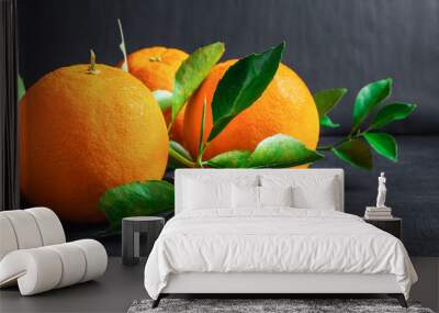 Fresh orange and leaf on black background Wall mural