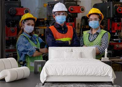 Group of man and woman workers or engineer also manager with hygiene mask stand in confident action in workplace the factory during concern about public health of corona virus pandemic in people. Wall mural