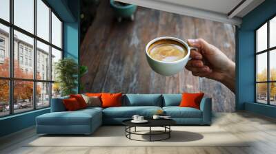 Hot espresso cup in hand Wall mural