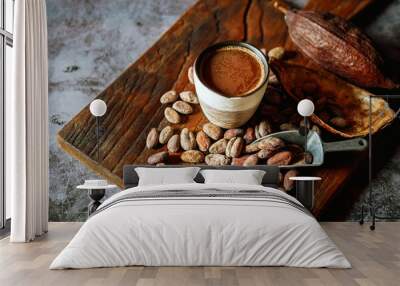 Natural craft cocoa drink, organic healthy chocolate drink with brown cocoa beans and dry cacao pod.Top view,above Wall mural